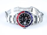 a close up of a wrist watch on a white surface