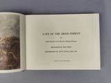an open book with a picture of a man and a woman in a forest