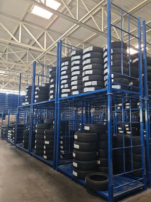 a large amount of tires are stacked on a rack in a warehouse