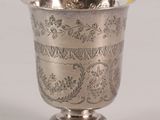 a silver cup that is sitting on a table