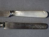 two knives that are sitting next to each other on a table