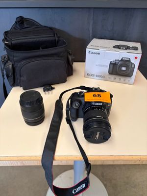 a camera on a table next to a camera bag