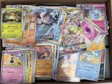 a lot of pokemon cards in a box on the table
