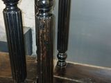 two black wooden tables with ornate carvings on them