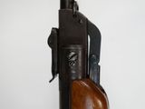 a close up of a rifle with a wooden handle on a white background