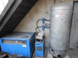 a large tank and a small blue machine in a room