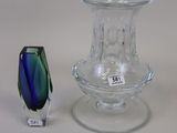 a small glass vase and a small glass vase on a table