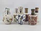 five different vases sitting next to each other on a table