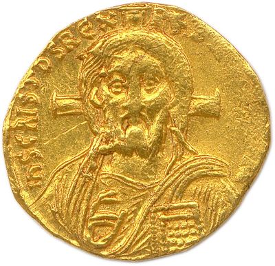 a close up of a gold coin with a man on it