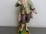figurine of a man holding a bird in his hand