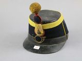 a black hat with a yellow band and a brown pom pom