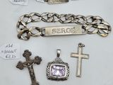 three silver bracelets, a cross, and a bracelet with a name tag