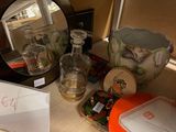 a table with a mirror, a vase, and other items on it
