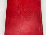 a red book sitting on top of a white surface