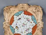 une image représentant une assiette ornée d'une fleur, posée sur une surface grise