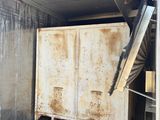 a large metal container in the back of a truck