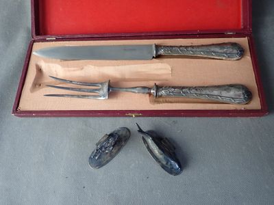 three knives and a knife sharper in a red case