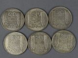 six silver coins with the names of different countries on them
