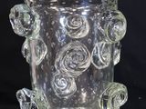 a glass vase that has a bunch of flowers on it
