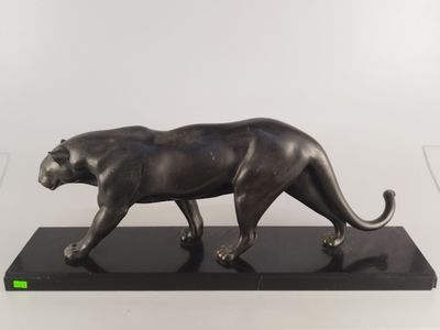 une image représentant une statue en bronze d'une panthère posée sur un socle noir