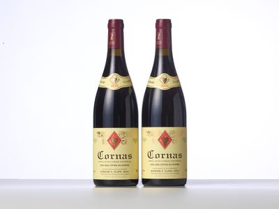 two bottles of red wine sitting next to each other on a table