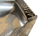 a silver plate with a metal handle on it