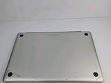the back of a silver laptop computer sitting on top of a white table