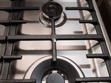 a silver stove top with a black burner and two burners