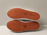 the soles of a pair of shoes on a white surface