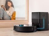 a robot that is sitting on the floor in front of a mirror