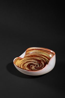 a close up of a small bowl on a black surface