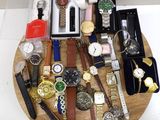 a wooden tray with a bunch of watches on it