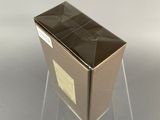 clear acrylic box with a black lid on a clear stand