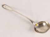 a spoon that is sitting on a white surface