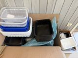 a cardboard box filled with plastic containers and plastic containers