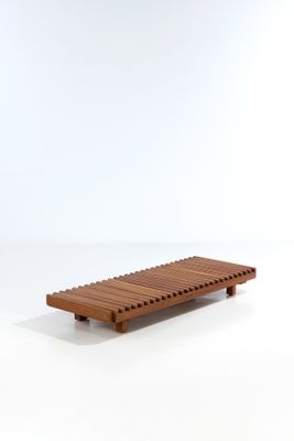 a wooden bench that is sitting on a white surface