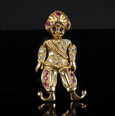une figurine plaquée or représentant un homme coiffé d'un chapeau rouge et blanc
