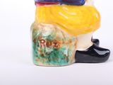 a ceramic figurine of a man with a hat on his head