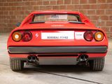 a red sports car parked in front of a brick wall