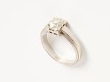 a close up of a ring with a diamond on it