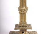 a gold candle holder on a white background