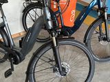 two electric bikes parked next to each other in a room