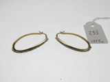 a pair of gold hoop earrings with black and white stones