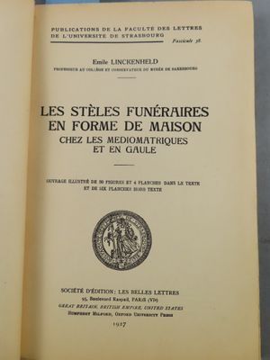 an open book sitting on top of a table next to a glass