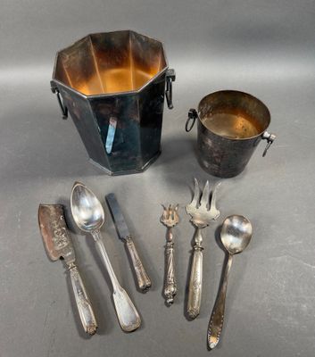five silver spoons and a bucket of silverware on a table