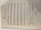 the book is open on a white table with a red marker