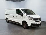 the white van is parked in the large room of the building