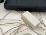a laptop computer sitting on top of a desk with a charger
