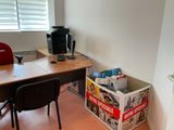 a desk and a chair in the corner of a room
