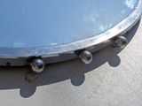 a close up of a mirror with rivets on it